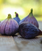 Violette de Bordeaux dark purple fruit sitting on wooden table